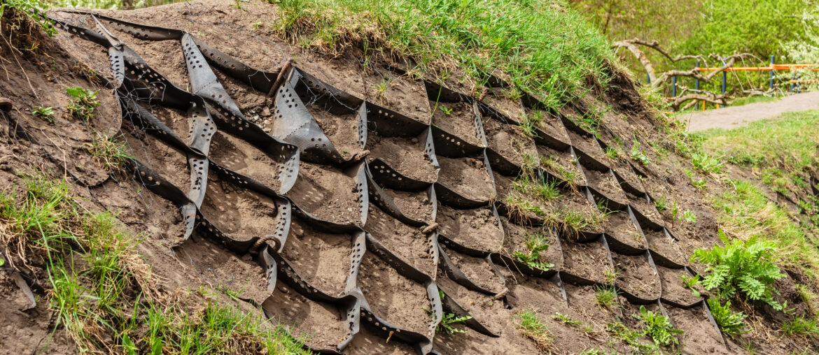 Strengthening the slope soil with volumetric geogrid. Polymer Geogrid Retaining Wall in the garden or park to protect slopes