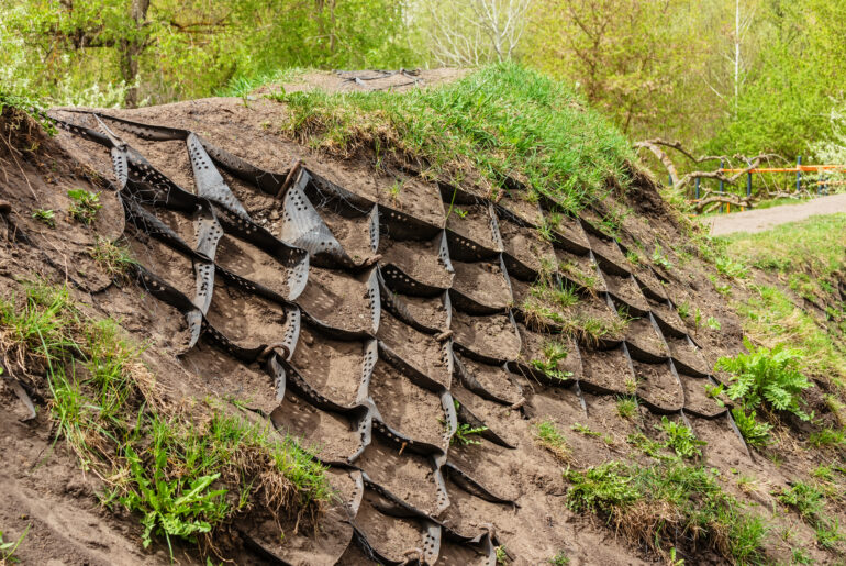 Strengthening the slope soil with volumetric geogrid. Polymer Geogrid Retaining Wall in the garden or park to protect slopes