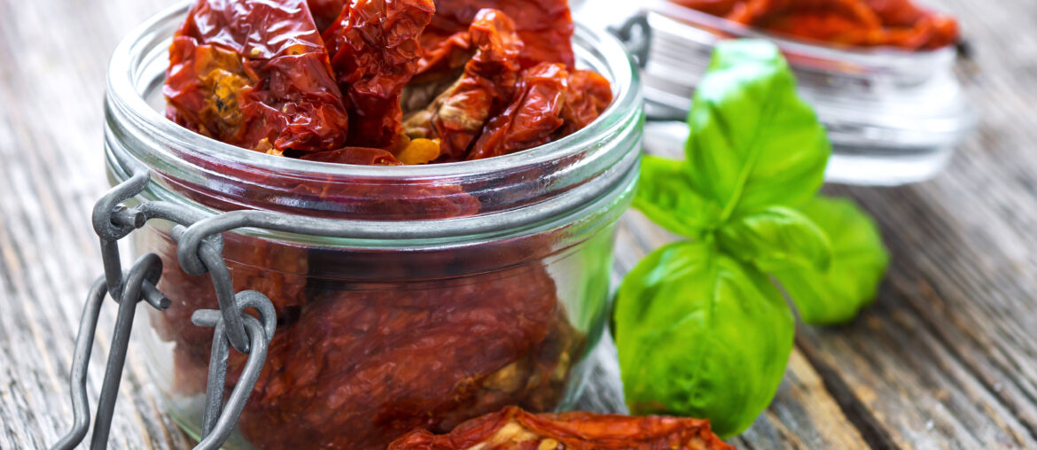 Sun dried tomatoes on wooden background