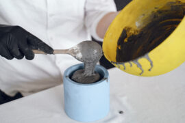 Man works with a cement. Concrete cement grey pot. Hand made concrete planters for succulents and cacti.