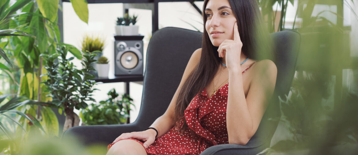 Woman relaxing in a room with many plants