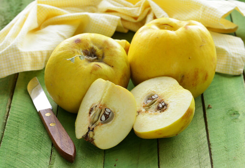 ripe yellow quince on a wooden table