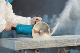 Worker cuts stone grinding machine